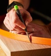 Drawing a curved line on wood using a Pica-Dry Mechanical Pencil and a drawing bow