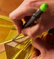 Drawing a straight line on wood using a Pica-Dry Mechanical Pencil and a template