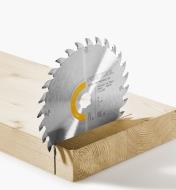 A universal blade standing upright on a solid wood plank