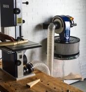 Rikon 1 hp Wall-Mount Dust Collector connected to a table-top bandsaw