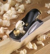 Veritas Standard Block Plane on a workpiece surrounded by wood shavings