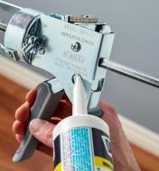 Trimming the nozzle of a caulk tube using the spout cutter