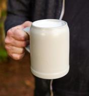 A person holds a filled Keferloher Beer Stein