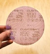 Showing the spiral hole pattern of the 3M Cubitron sanding disc