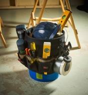 The 48-pocket tool carrier filled with tools and mounted on a bucket
