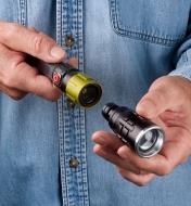 Inserting the flashlight head into the quick-change collet of the 3-in-1 work light