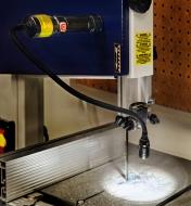 A 3-in-1 work light mounted magnetically to illuminate a bandsaw table with the flex-neck head