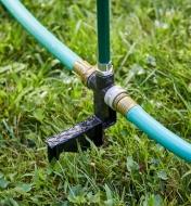 Two garden hoses attached to the inflow and outflow ports in the sprinkler base