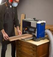 Feeding a plank into the Rikon 13" helical planer