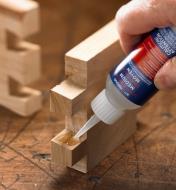 Applying Starbond medium CA glue to a tail of a dovetail joint