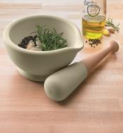 Milton Brook Mortar & Pestle on a counter, filled with herbs ready to be ground