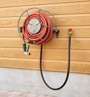 Hose Reel holding a hose, mounted on a wall in the closed position