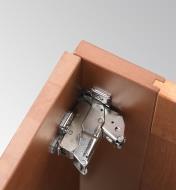A standard 155° soft-close clip-top half overlay hinge is hidden by a closed cabinet door