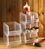 Five stackable light-duty storage bins used in a workshop to hold glue, paintbrushes and small tools