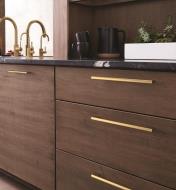 Champagne Bronze Versa Handles installed on kitchen cabinets