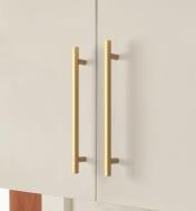 Champagne bronze Caliber handles mounted vertically to cupboard doors