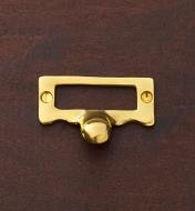 A brass card frame fastened with brass screws