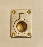 Brass recessed finger pull fastened with brass screws