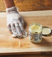 Odie’s Wax being applied to a wooden surface