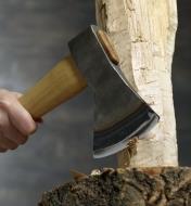 A carving axe is used to carve the side of a log