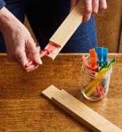Spreading glue on a wooden joint using a glue spreader