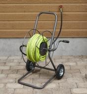 Hose reel cart holding garden hose on a patio
