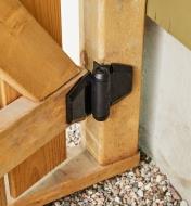 A standard wrap gate hinge installed on a wooden gate