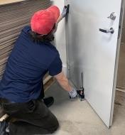 Using a Viking Arm assembly jack to support a door while installing it