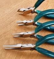 Three pliers and side cutters lined up with open jaws