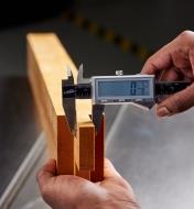 Using an electronic caliper to measure the width of a tenon joint