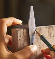 Using a pencil to mark out dovetails using the template