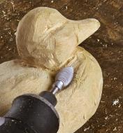 Using a flame-shaped Kutzall rotary carving burr to sculpt the neck contours of a duck carving