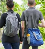 One person wearing a packable backpack and another person carrying a packable shoulder bag