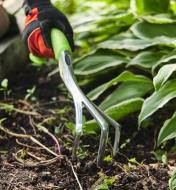 Weeding a garden bed using a Radius ergonomic hand cultivator