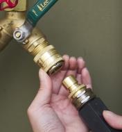 Connecting a garden hose to an outdoor faucet using a brass quick-connect coupler