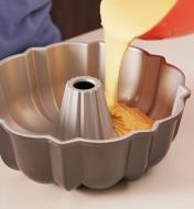 Cake batter being poured into a Bundt pan