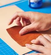 Positioning the card pocket on the left side pocket of the leather journal cover