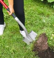 Digging out turf with the long-handled round-point shovel