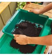 Sifting soil through a soil sieve