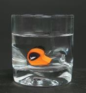 A moldable ear plug from the custom ear plug kit immersed in a glass of hot water