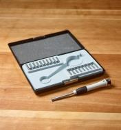 A small screwdriver next to a case filled with multiple tips