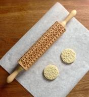 Two baked cookies made with dough embossed by the holiday sweater rolling pin
