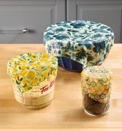 Three sizes and shapes of containers covered in beeswax wraps