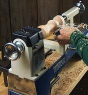 Applying a chisel to wood that is turning on a lathe