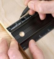 Marking a sheet of plywood using a Veritas shop rule to measure from a panel edge 