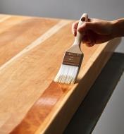 Applying finish to a large, flat surface using the 2" chiselled wedge brush
