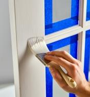 Applying paint to a French door using the 2" angled stubby-handle brush