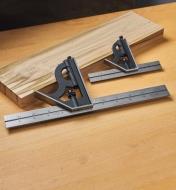 Two sizes of combination squares leaning against a wooden board