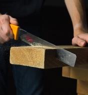 Using a Japanese utility saw to saw through a board