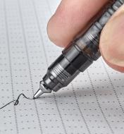 A close-up view of the tip of the mechanical pencil writing on paper 